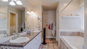Full bathroom featuring a bath, double vanity, and Separate Shower