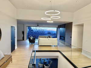 Hall featuring light wood-style floors and a high ceiling