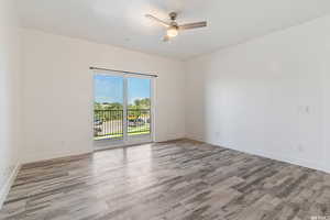 Unfurnished room with a ceiling fan and light wood finished floors