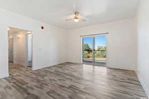 Unfurnished room with ceiling fan and light wood-style floors