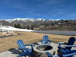 View of patio / terrace with a fire pit and a mountain view