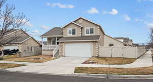 View of front of house featuring a gate, a shingled roof, driveway, a garage, and stucco siding