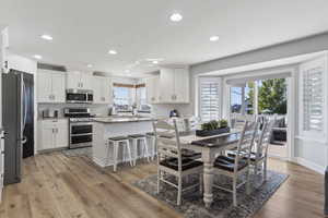 Dining space with recessed lighting and light wood-style flooring