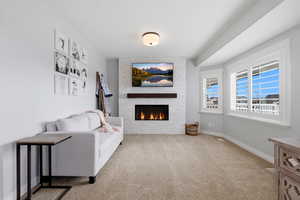 Living room with a fireplace and light carpet