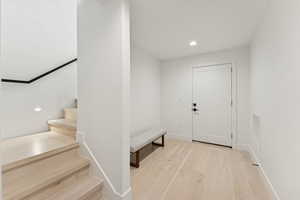 Foyer entrance with recessed lighting and light wood-style flooring
