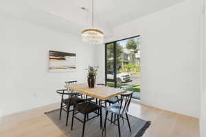 Dining room featuring light wood-style floors and a chandelier