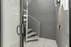 Stairs with tile patterned floors