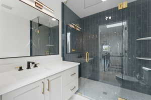 Bathroom with vanity and a shower stall