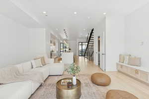 Living room featuring light wood finished floors and recessed lighting