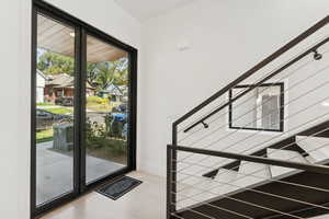 Entryway with stairs and wood finished floors