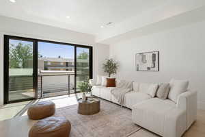 Living area with wood finished floors and recessed lighting