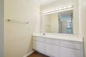 Bathroom featuring vanity and crown molding