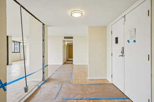 Entrance foyer with parquet flooring and baseboards