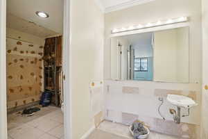 Bathroom featuring a shower and light tile patterned floors