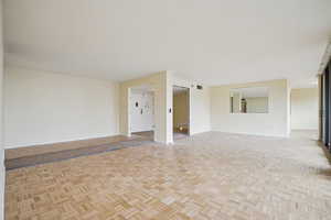 Unfurnished room featuring parquet flooring