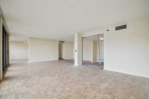 Unfurnished room featuring parquet flooring