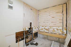 Full bath featuring concrete floors and a shower