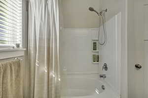 Bathroom with shower / tub combo with curtain