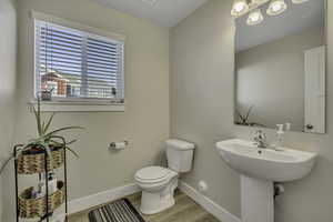 Bathroom featuring baseboards and light wood finished floors