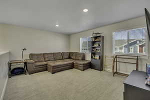 Living room with light carpet and recessed lighting