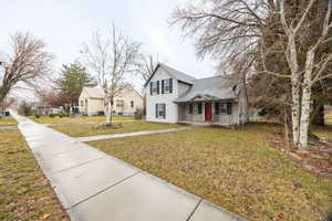 Traditional home with a front lawn and a porch