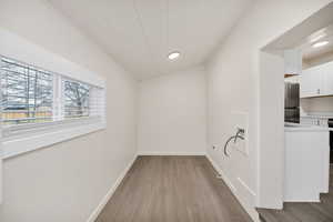 Unfurnished dining area featuring light wood-style floors, crown molding, lofted ceiling, and recessed lighting