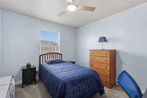 Bedroom with carpet flooring and a ceiling fan