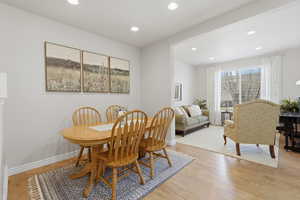 Dining area featuring light wood-style floors and recessed lighting
