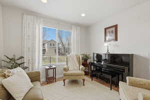 Living area with wood finished floors and recessed lighting