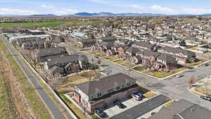 Aerial view of property's location with a mountain backdrop and nearby suburban area