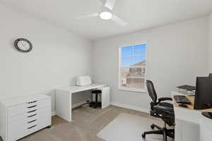 Office space featuring light colored carpet and ceiling fan