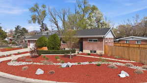 View of front of property with a garage, brick siding, and concrete driveway