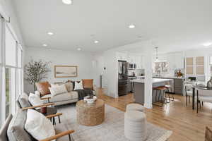 Living area featuring healthy amount of natural light, light wood-style flooring, and recessed lighting