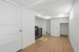 Laundry area with recessed lighting, washing machine and clothes dryer, and light wood-type flooring