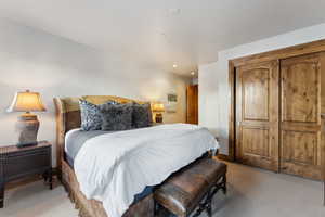 Bedroom with light carpet, a closet, and recessed lighting