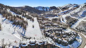 Snowy aerial view featuring a mountain view