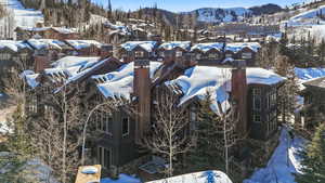Exterior view of stone siding and a mountain backdrop