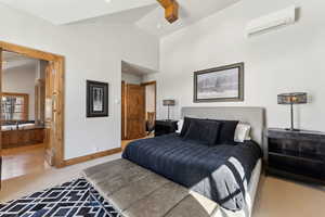 Bedroom featuring vaulted ceiling, light colored carpet, and a ceiling fan