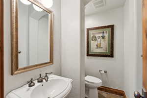 Bathroom with toilet and a textured wall