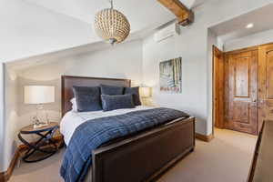 Bedroom featuring light colored carpet, recessed lighting, and beam ceiling