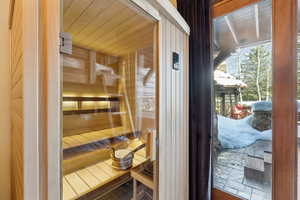 Sauna featuring wooden walls and wood ceiling