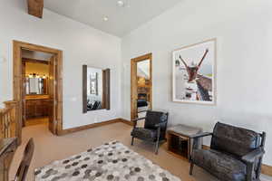 Sitting room with a stone fireplace and recessed lighting