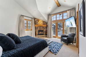 Carpeted bedroom featuring access to outside, a fireplace, and recessed lighting