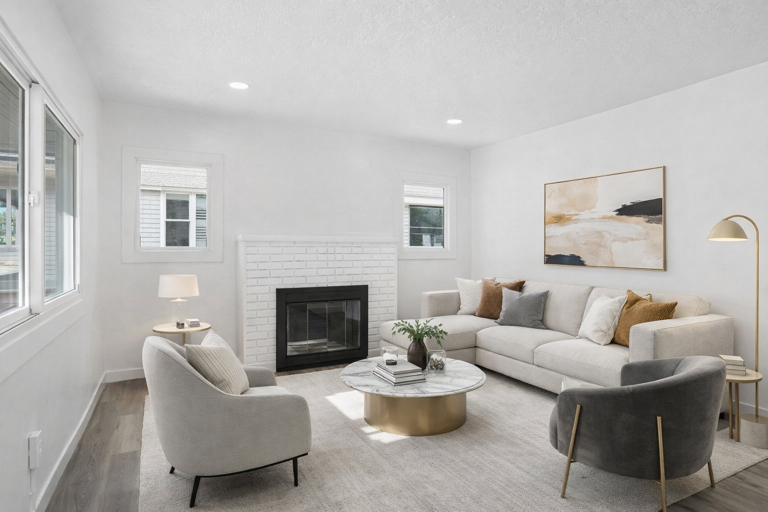 Living area with a brick fireplace, wood finished floors, and recessed lighting