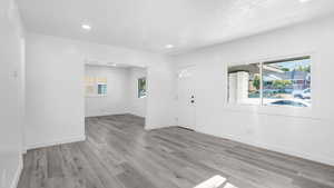 Entryway featuring light wood-style floors, recessed lighting, and a textured ceiling