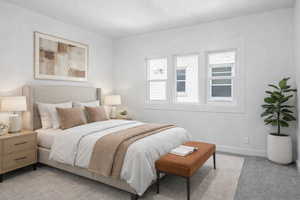 Bedroom with light carpet and baseboards