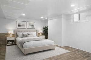 Bedroom with wood tiled floors and recessed lighting