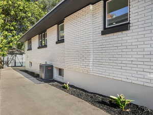View of home's exterior with brick siding and a central air condition unit