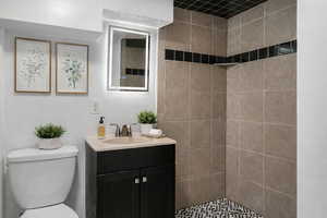 Full bath with vanity and a shower