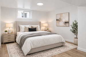Bedroom featuring wood finished floors and baseboards